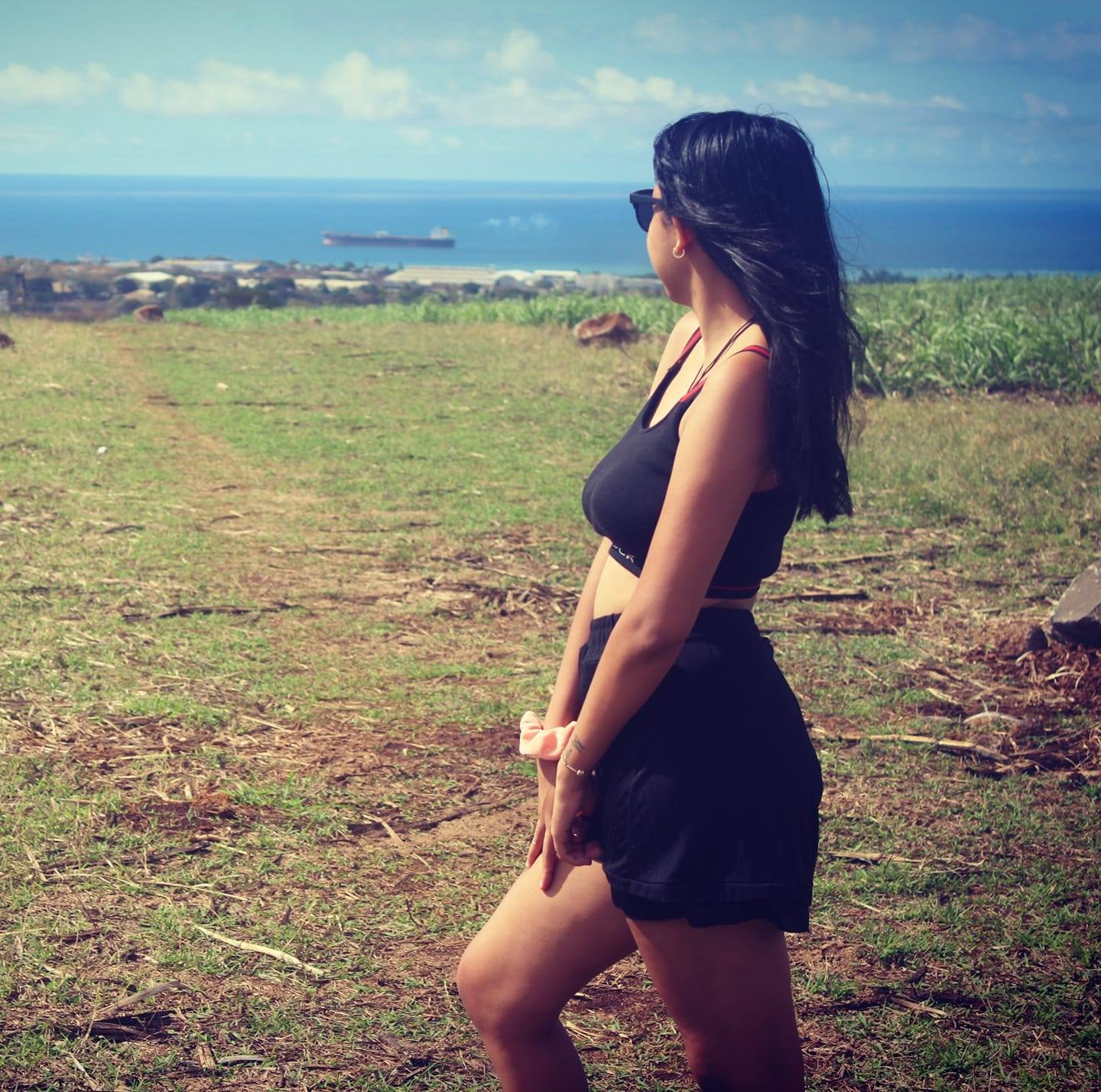 Former school pupil in a field facing the sea